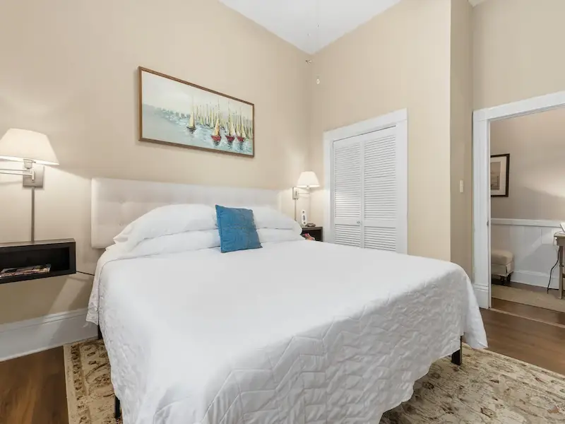 Suite 314A king bedroom at The Wilder House Savannah â€” tufted headboard premium white linens large window natural light