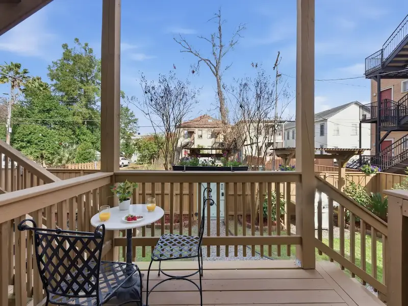 Suite 314A private deck at Forsyth Park vacation rental Savannah â€” bistro table chairs garden view morning coffee