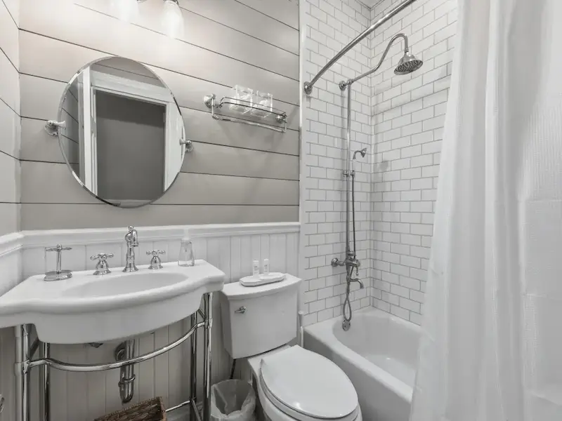 Suite 314A bathroom at The Wilder House Savannah â€” subway tile rain shower pedestal sink chrome fixtures