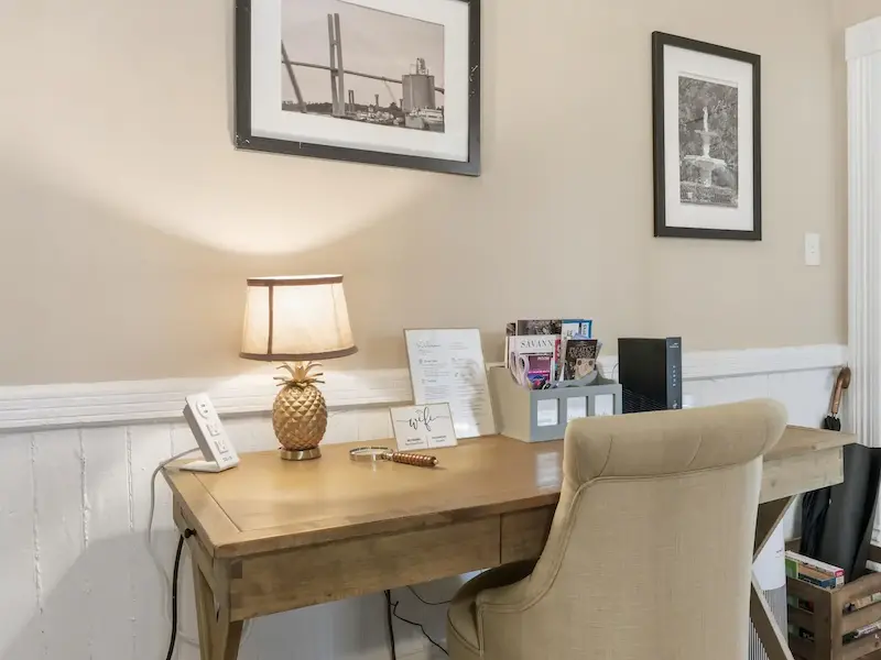 Suite 314A dedicated workspace at The Wilder House Savannah â€” wooden desk Savannah art prints 279 Mbps WiFi seagrass hallway