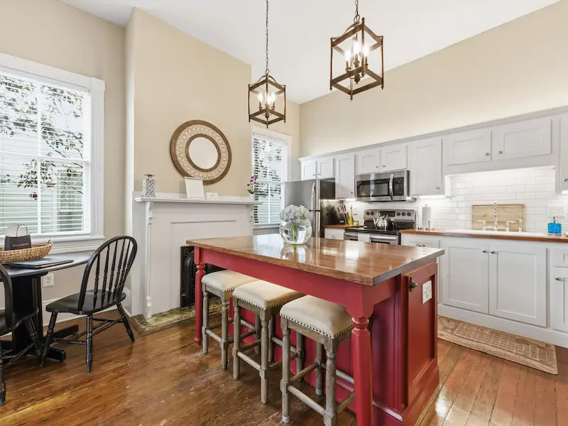 Suite 314A Savannah vacation rental fully stocked kitchen â€” maroon island bar stools white cabinets stainless appliances