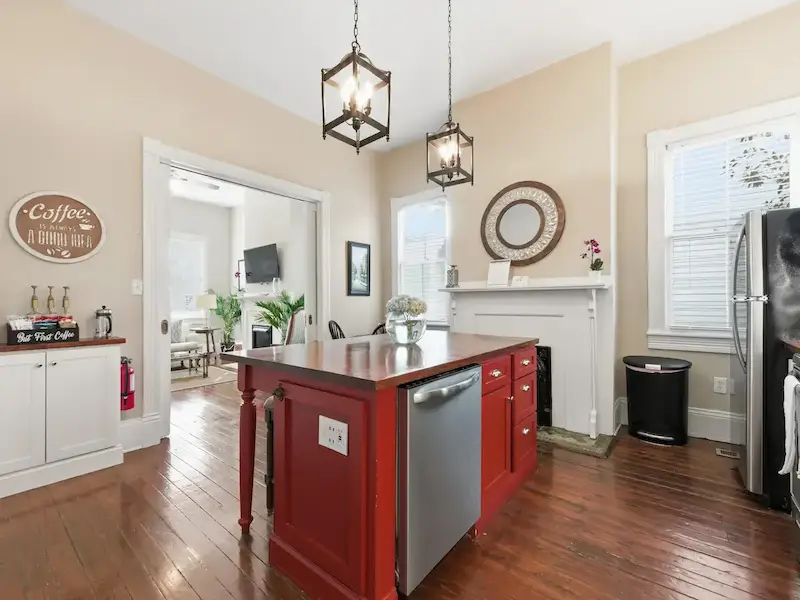 Suite 314A Wilder House kitchen and dining area â€” maroon island with dining nook heart-pine floors
